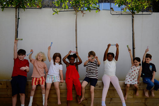 Kids sitting on a wall enjoying themselves