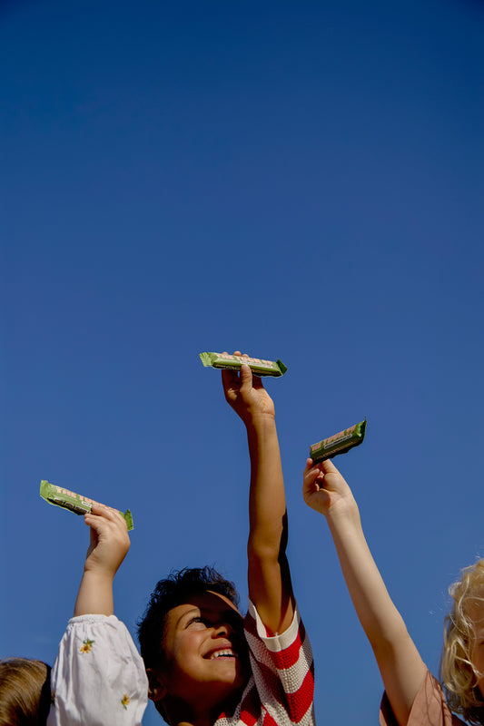 Kids holding up snacks