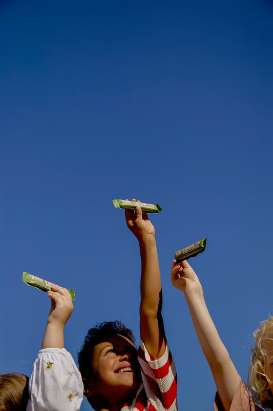 Kids holding up snacks
